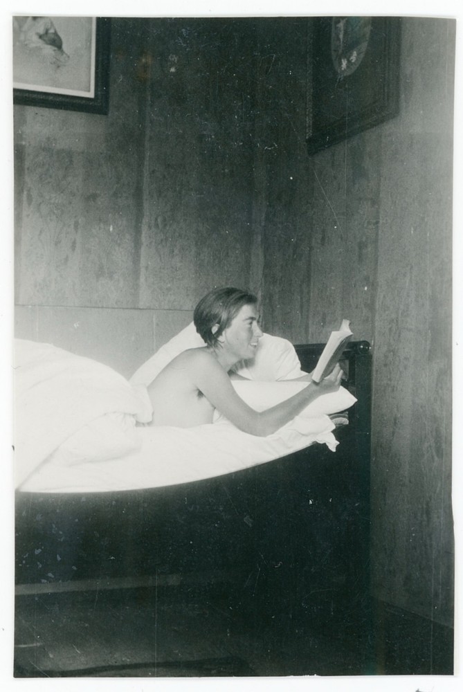 Young Woman Nude Reading Book In Bed Laughing Nude Vintage