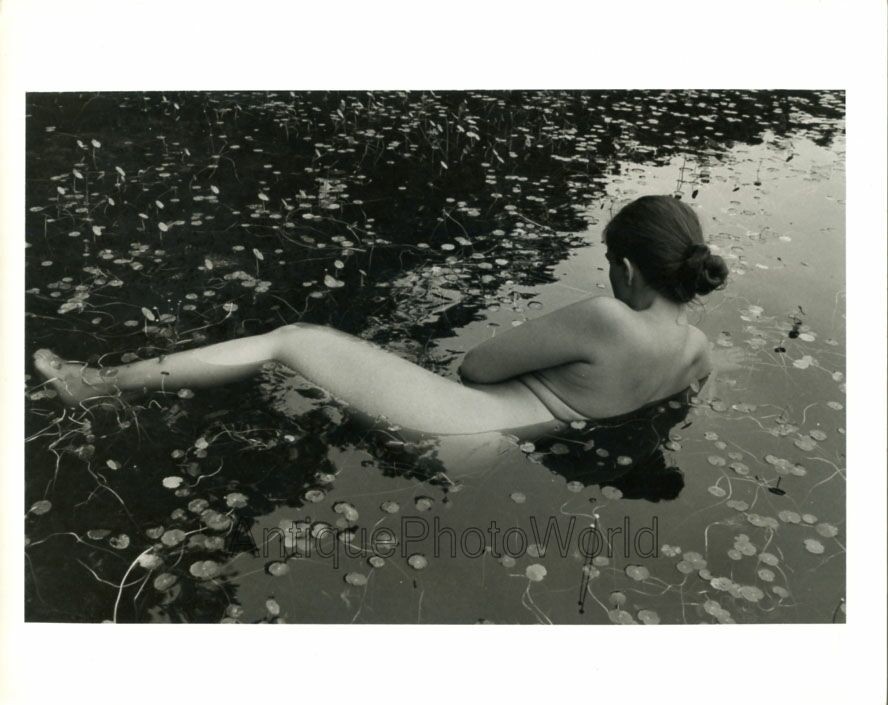 Nude woman posing in pond with water lilies vintage art photo