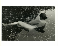 Nude woman posing in pond with water lilies vintage art photo