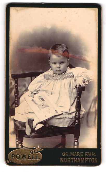 Photograph Powell, Northampton, Mare Fair 62, Toddler in White Dress with Lei