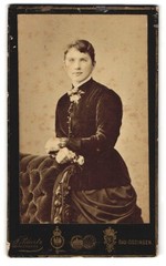 Photograph J. Pilartz, Bad Kissingen, woman in elegant dress next to padded