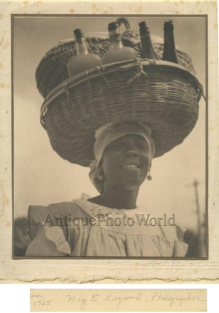 Woman carrying bottles on head antique art photo Caribbean