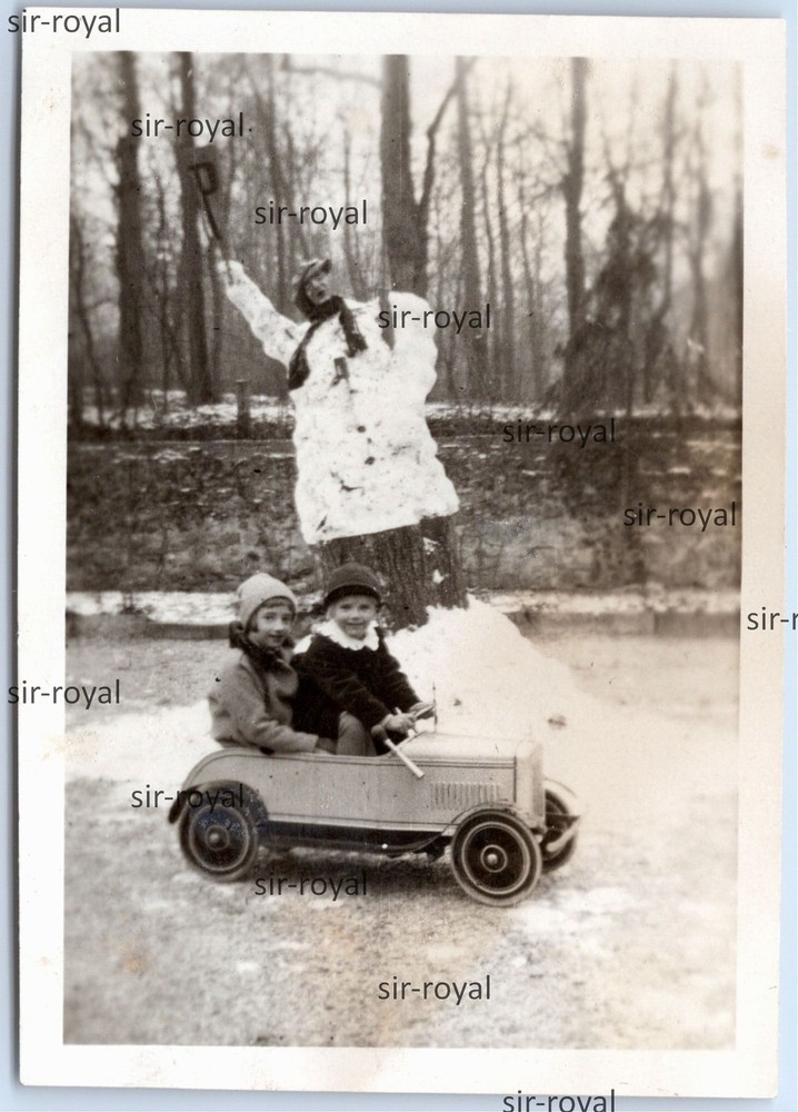 Children in Pedal Car in Front of Snowman – Toy Children’s Car Vehicle – Photo 6x8cm