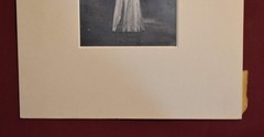 Vintage Photograph of a Woman Wearing a White Dress and a Black Hat