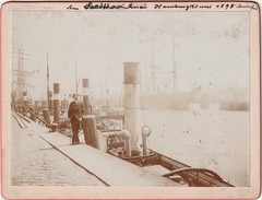 Photograph from 1898 of an elegant gentleman at the port in Hamburg, photo including steamer