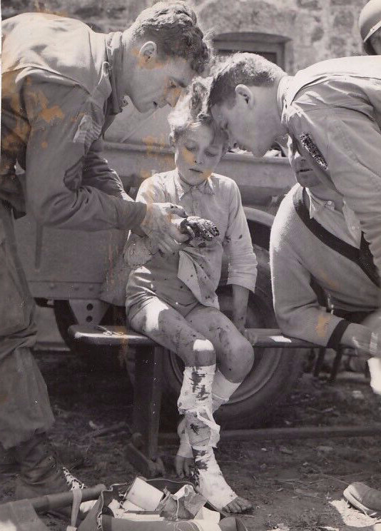 Harry Harris – WWII Americans healing a chid injured by grenade – vintage print