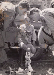 Harry Harris – WWII Americans healing a chid injured by grenade – vintage print