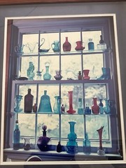 “Sunlit Memories in Colored Glass Bottles” Framed Photograph 21.5” X 25.5”