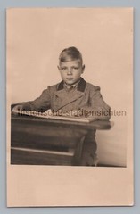 Boy with school bench – school portrait – enrollment – old photo