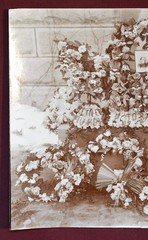 Antique Photograph Depicting a Woman’s Memorial with a Floral Arrangement