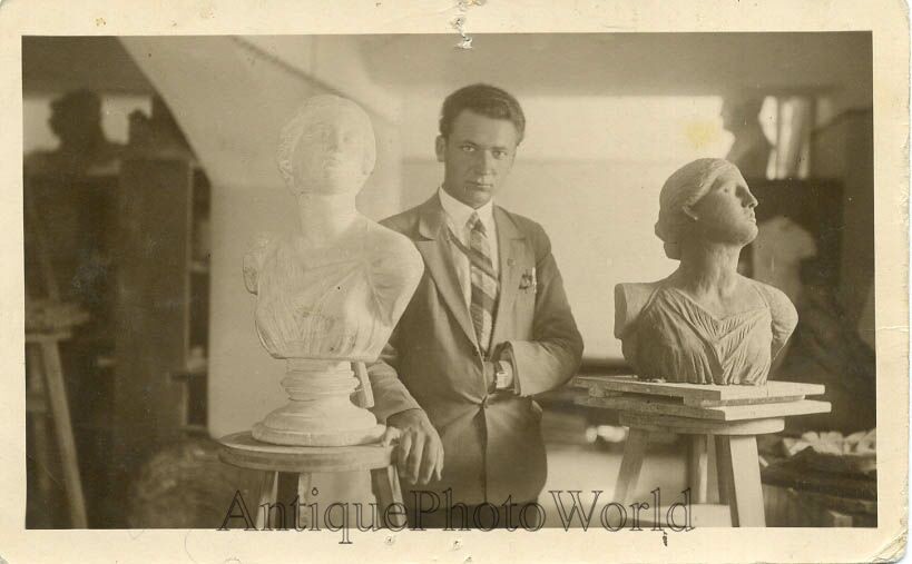 Sculptor artist with statues antique photo